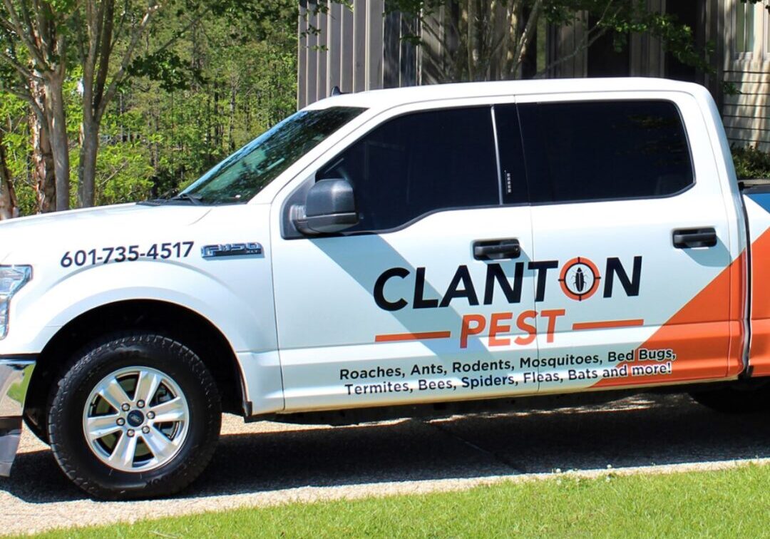 A white truck with the words clanton pest on it.